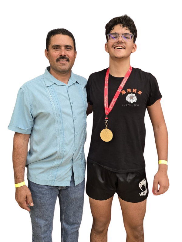 Elevate teen athlete wearing a medal beside a proud coach