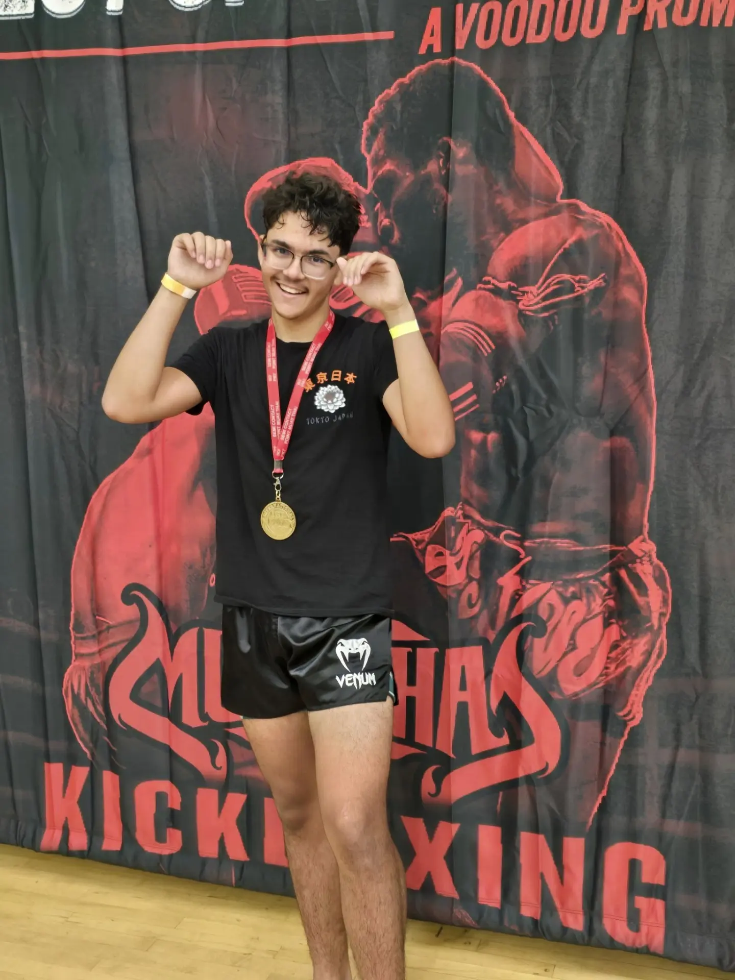 Elevate Martial Arts student celebrating with a medal